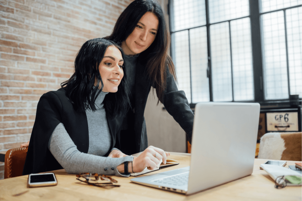 two women looking at a laptop