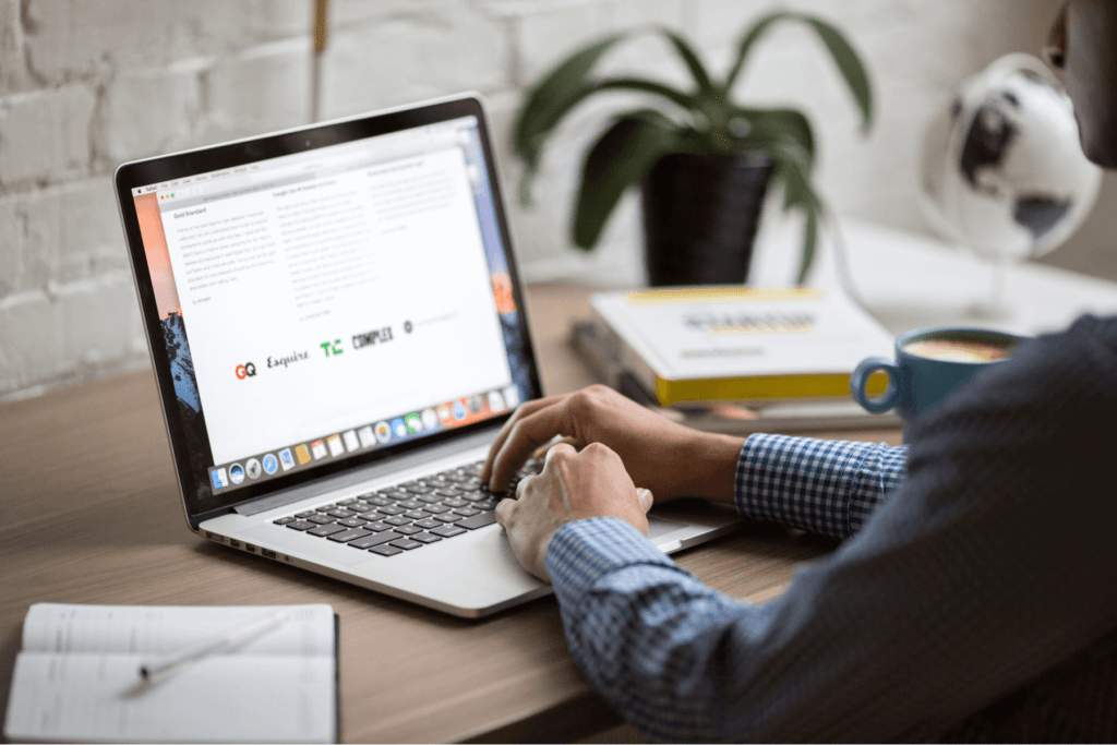 a person reading guidelines on a laptop