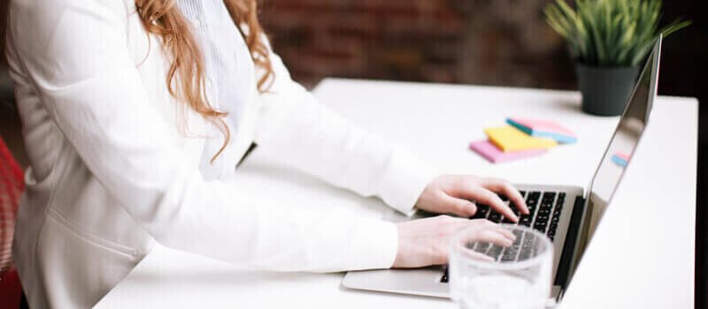 a person typing on a laptop