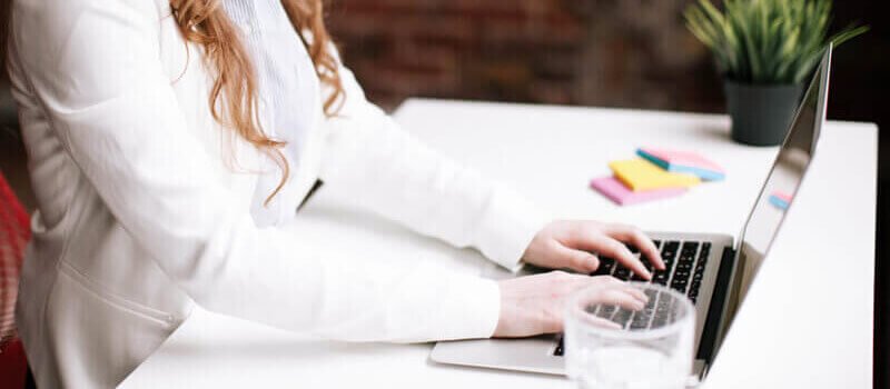 a person typing on a laptop
